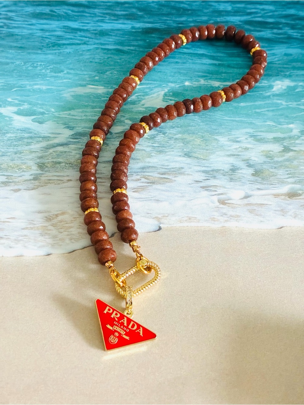 Unbranded Brown Beaded Necklace with Red Triangle Logo Charm
